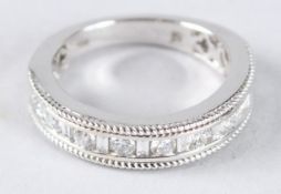 AN 18CT WHITE GOLD, BAGUETTE AND ROUND CUT DIAMOND HALF HOOP RING.