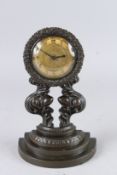 A GOOD REGENCY BRONZE WALL CLOCK with gilded face, on a bow fronted stepped base. 10ins high.
