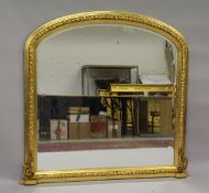 A LARGE GILTWOOD DOMED TOP OVERMANTLE MIRROR. 6ft high x 4ft 8ins wide.