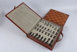 A TAN LEATHER CASED CHESS SET.