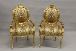A GOOD PAIR OF LOUIS XVITH GILTWOOD ARMCHAIRS with padded back, arms and seat.