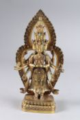 A CHINESE GILT BRONZE MULTI ARM DEITY. 11ins high.