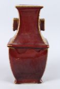A CHINESE RED RECTANGULAR TWO HANDLED ARROW VASE, six character mark. 15ins high.