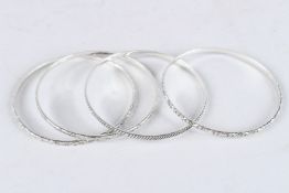 A STERLING SILVER THREE ROW BANGLE.