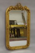 A LOUIS XVITH STYLE GILTWOOD UPRIGHT MIRROR with ribbon motifs. 6ft high x 2ft 7ins wide.