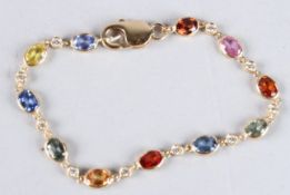 AN 18CT GOLD AND MULTI-COLOURED SAPPHIRE AND DIAMOND LINE BRACELET.