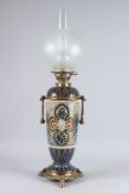 A VERY GOOD DOULTON LAMBETH STONEWARE OIL LAMP with gilt metal mounts and shade.