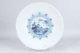 A LARGE 18TH CENTURY DUTCH TIN GLAZE CIRCULAR DISH decorated with two men fishing. 16ins diameter.