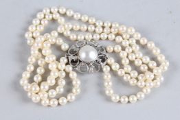 A GOOD TRIPLE ROW PEARL CHOKER with 18ct white gold, pearl and diamond clasp.