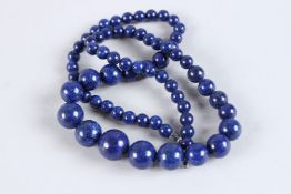 A STRING OF LAPIS BEADS. 20ins long.