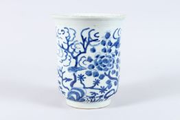 A CHINESE PORCELAIN BLUE AND WHITE VASE, painted with birds in a flowering tree. 21cms high.
