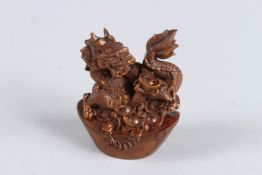 A HARDWOOD CARVED DRAGON on a boat. 2.75ins.