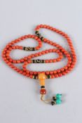 AN ORANGE BEAD NECKLACE. 32ins long.
