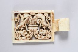 A CHINESE CARVED AND PIERCED WHITE JADE TABLE TOP CLIP. 2.25ins x 1.75ins.