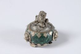A SMALL ANTIQUE CHINESE GREEN JADE AND SILVER CIRCULAR CENSER, the lid with a foo dog. 2.2ins high.