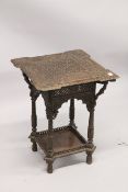 AN ISLAMIC CARVED SQUARE TWO TIERED TABLE with allover carved decoration. 1ft 7ins square x 2ft