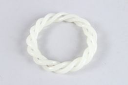 A CHINESE WHITE JADE ARTICULATED BANGLE. 3.5ins diameter.