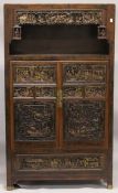 A VERY GOOD CHINESE LACQUERED CABINET inset with numerous carved panels of very high quality. The