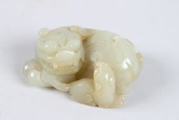 A FINELY CARVED 19TH - 20TH CENTURY CHINESE JADE CARVING OF A LION. 2.5ins diameter.