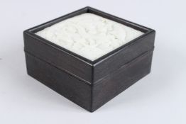 A JAPANESE HARDWOOD BOX mounted with a jade panel.