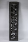 A LARGE, possibly Burmese, CARVED WOOD PANEL, carved with seven figures. 52ins high x 13ins wide.