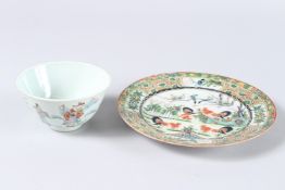 A CHINESE FAMILLE ROSE CIRCULAR BOWL, 4ins diameter, and a cock fighting plate, 7ins diameter (2).