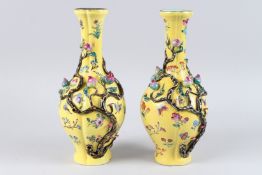 A PAIR OF CHINESE YELLOW GROUND VASES with peaches in relief. Square mark in blue.