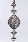 A PERSIAN PIERCED METAL ARM BAND.