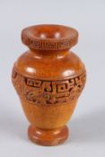 A CHINESE CARVED HORN VASE, the sides with a band of key pattern. 6ins high.