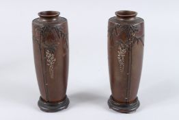 A GOOD PAIR OF JAPANESE BRONZE SILVER INLAID VASES decorated with bamboo. Signed. 6ins high.
