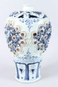 A LARGE CHINESE BLUE, WHITE AND IRON RED MEIPING VASE, with moulded decoration. 42cms high.