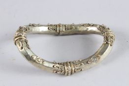 A CHINESE WHITE METAL DECORATIVE RING.