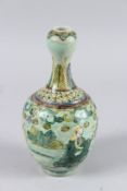 A CHINESE VASE decorated with figures and a face. 8ins high.