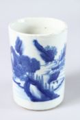 A CHINESE BLUE AND WHITE CIRCULAR BRUSH POT with landscape design. 6.5ins high x 4.25ins diameter.