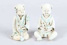 TWO CHINESE YING QING GLAZED FIGURES OF A BOY AND A GIRL.