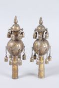 A PAIR OF JEWISH BRASS DECORATED CEREMONIAL FINIALS with hanging bells. 9ins high.