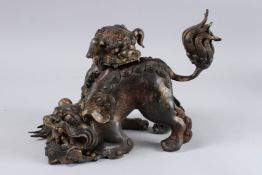 A LARGE CHINESE BRONZE FOO DOG CENSER. 12ins long.