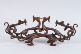A CHINESE BRONZE DRAGON GROUP. 13ins long x 5.5ins high.
