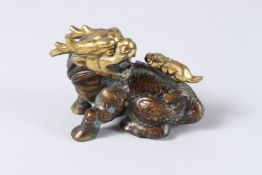 A SMALL CHINESE BRONZE GILDED DOG OF FOO. 5ins long.