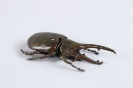 A JAPANESE OKIMONO BRONZE EASTERN HERCULES BEETLE with articulated wing.