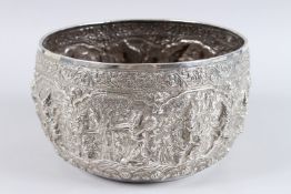 A VERY GOOD BURMESE SILVER CIRCULAR BOWL, the side repousse with dancers. 10ins diameter x 6ins