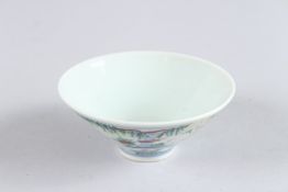 A SMALL CHINESE PORCELAIN BOWL, the sides with figures. 3.5ins diameter.