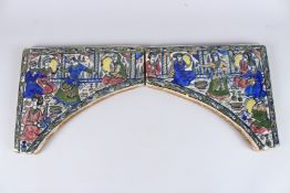 A FINE PERSIAN QAJAR GLAZED POTTERY ARCH TILES. 12ins x 17ins.