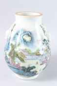 A CHINESE PORCELAIN LANDSCAPE PATTERN VASE with applied deer handles. 12ins high.