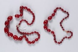 TWO CHERRY AMBER TYPE BEAD NECKLACES. 30ins and 11ins long.