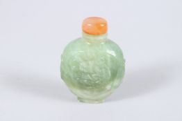 A CHINESE TWO COLOUR JADE SNUFF BOTTLE AND STOPPER, carved with dragons. 2.5ins high.