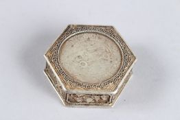 A CHINESE WHITE METAL OCTAGONAL COIN BOX set with two Chinese coins. 1.75ins.