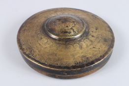 AN INDIAN BRASS LINE TRAVEL MIRROR, with mirrored panel and painted with figures. 10ins diameter.