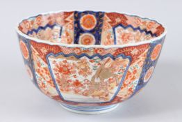 A JAPANESE IMARI DEEP CIRCULAR BOWL in red and blue, with dragons and flowers. 9.5ins diameter x 5.