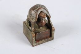 A CHINESE GROUP BRONZE SEAL.